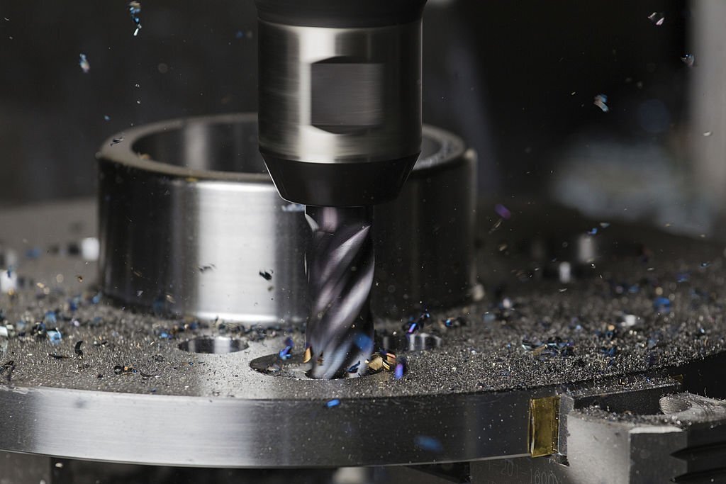 A hole is milled in a flange on a CNC machining center using a carbide endmill
